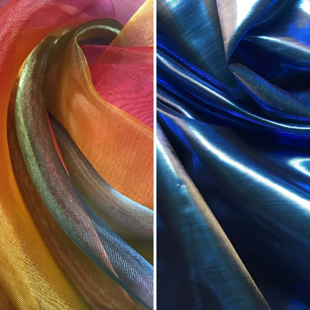 Two panels of worship flag fabrics displayed side-by-side. The left panel features a swirl of rainbow tones including yellow, orange, red, and hints of green and violet with a translucent shimmer. The right panel displays deep, glossy sapphire blue fabric with light reflections, creating a rich, fluid appearance.