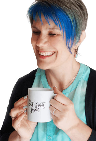 Andrea York, founder of Catch the Fire Worship Flags, smiling with a white coffee mug that reads 'But First, Jesus'—Christian entrepreneur and worship mentor.
