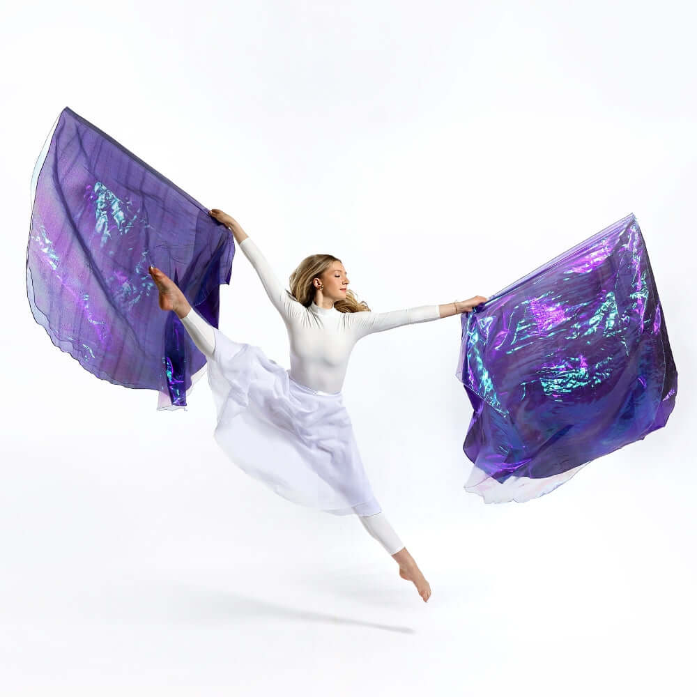 Elegant worship leap captured with Casting Crowns double-layer flags in shimmering purple and lilac, expressing full-body praise in a movement of surrender.