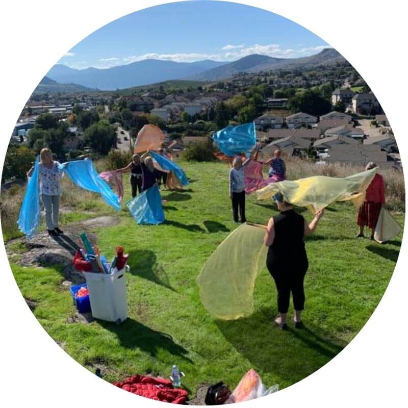 Group of worshippers waving colorful flags on a mountaintop during a Catch the Fire workshop, releasing intercession and praise over the city below.