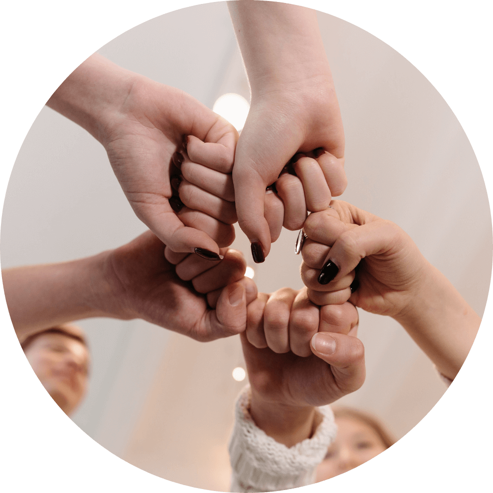 Close-up of fists joined in solidarity, reflecting worship warrior fellowship, agreement in prayer, and Kingdom community.