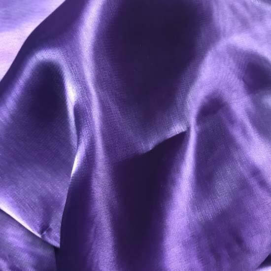 "Close-up of rich purple iridescent fabric with soft sheen and natural folds, ideal for worship flags or expressive movement textiles.