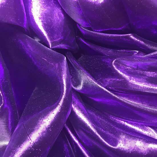 Close-up of rich, iridescent purple shimmer fabric with flowing texture, used in handcrafted worship flags.