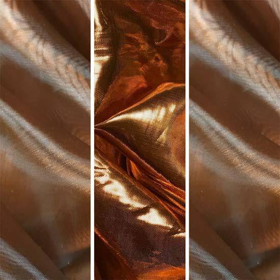 Close-up of shimmering bronze and copper iridescent fabrics, showcasing texture and metallic sheen used for worship flags or dance banners.