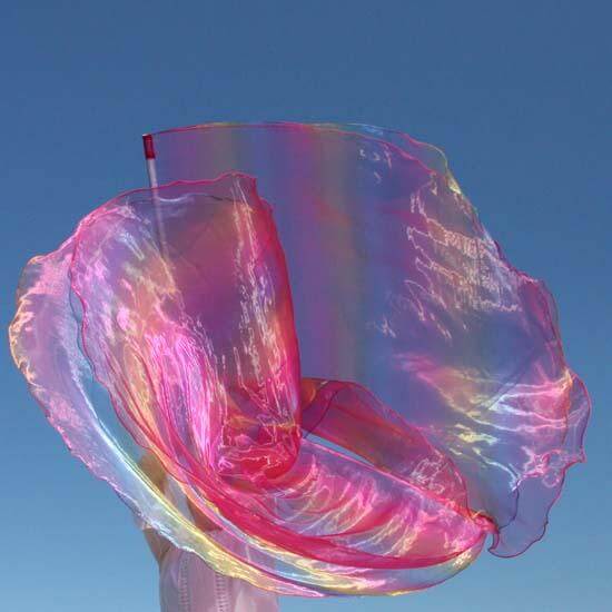 Flowing worship flag in scarlet and rainbow iridescent colors swirling against a clear blue sky, creating a vibrant and ethereal movement in mid-air.