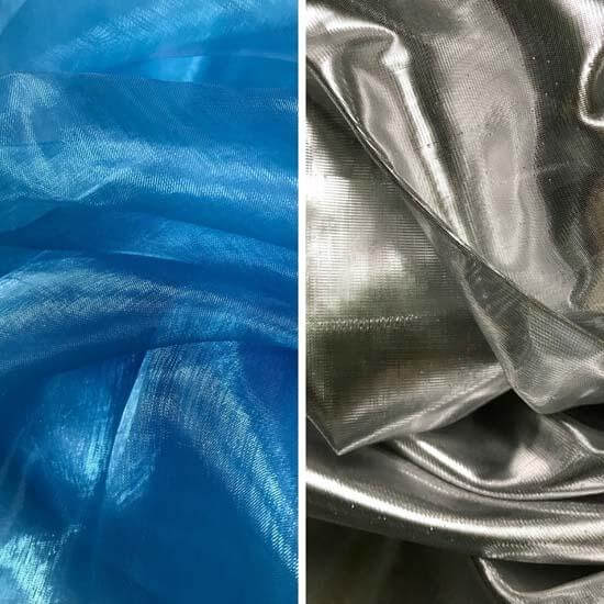 Close-up of iridescent fabric swatches in blue (left) and silver (right). Both materials have a soft shimmer and translucent quality, reflecting light with a glossy finish.