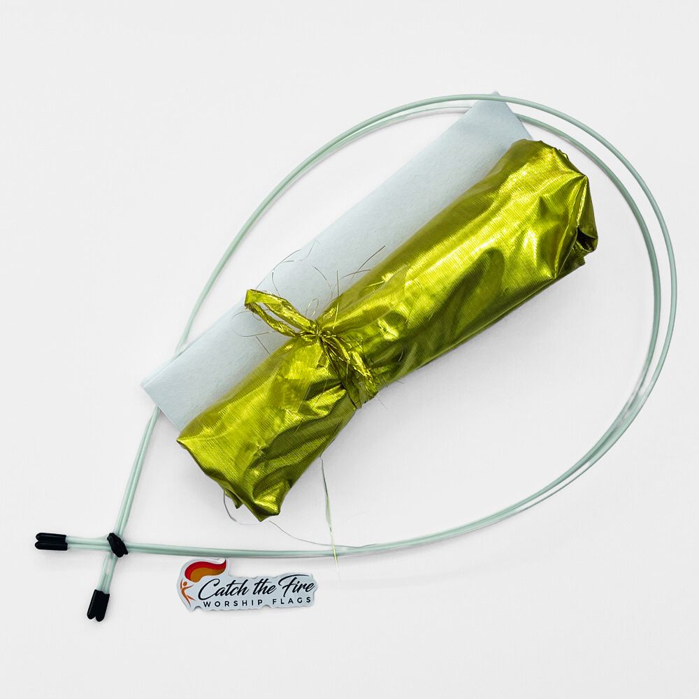 Gold worship flag kit with shimmer fabric, two flexible rods, white sleeve, and Catch the Fire Worship Flags logo displayed on a white background.