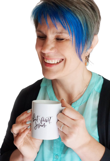 Andrea York, founder of Catch the Fire Worship Flags, smiling with a white coffee mug that reads 'But First, Jesus'—Christian entrepreneur and worship mentor.
