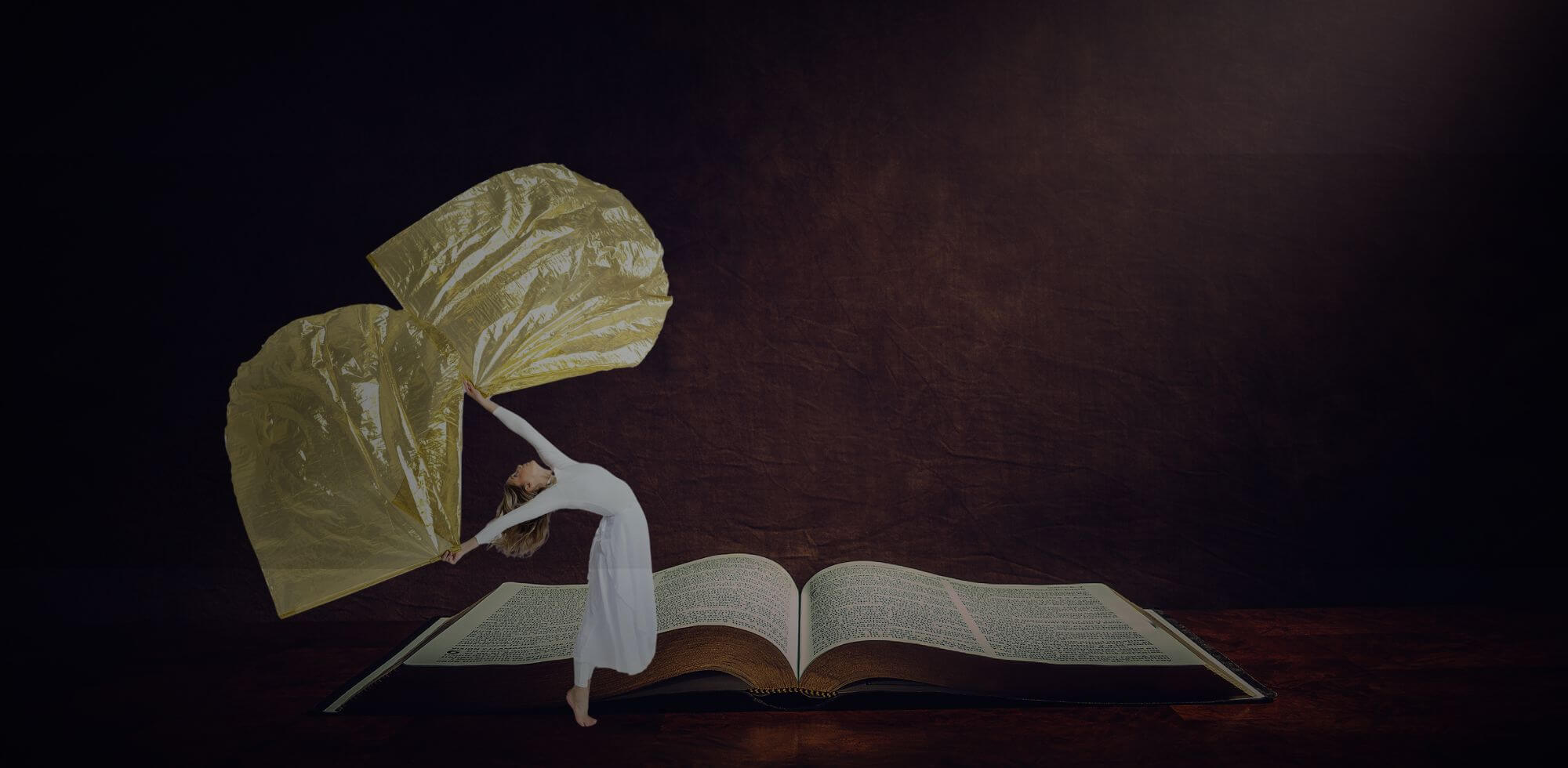 A worshipper dances with golden flags before an open Bible, symbolizing the union of Scripture and prophetic movement. This image captures the beauty of worship through color, motion, and the Word of God—expressing devotion and spiritual freedom.
