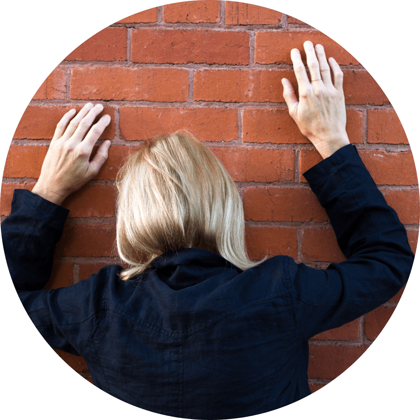 Frustrated woman facing a brick wall – symbolic image of hindrance or spiritual block in worship flag journey