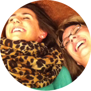 Two women lying on the floor laughing with joy — capturing the contagious joy and authentic connection found in Spirit-filled community through Catch the Fire Worship Flags.