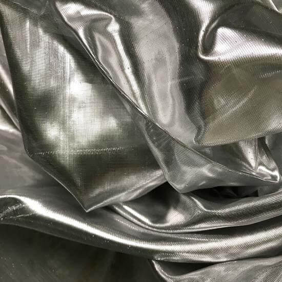 Close-up of metallic silver worship flag fabric, reflecting light with a fluid shimmer, symbolizing purity, redemption, and the refining fire of the Lord